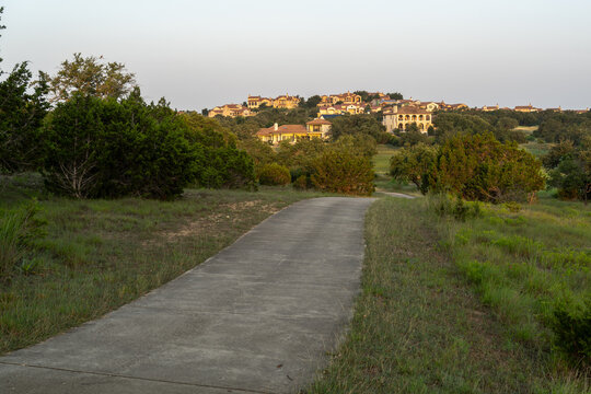 Texas Hill Country living, Mediterranean, Spanish-style architecture upscale houses topping a hill reached by a concrete driveway