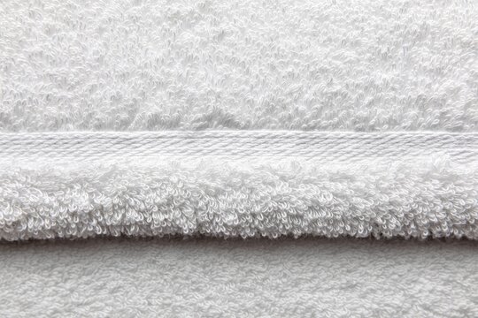 White towel fabric texture background, soft terry cloth spa material.