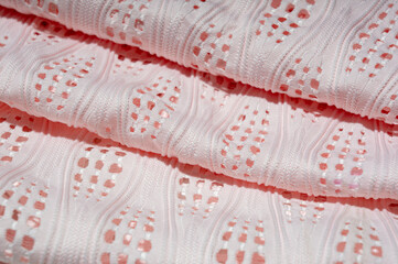 Close-up of patterned white fabric with holes