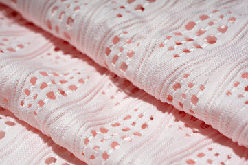 Close-up of patterned white fabric with holes