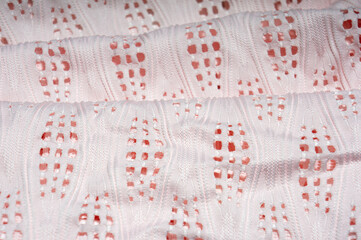Close-up of patterned white fabric with holes