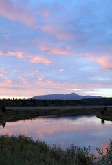 Pink clouds at sunrise reflected in water, Grand Teton National Park, Wyoming  USA
