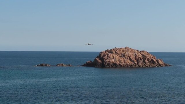 A rocky island sits in the middle of the ocean