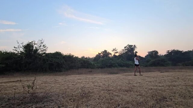 In shot put, unrecognized athlete starts crouched, rotates, uses explosive extension to push the heavy ball forward, transferring momentum from legs to arm for max distance. Maharashtra Bharati