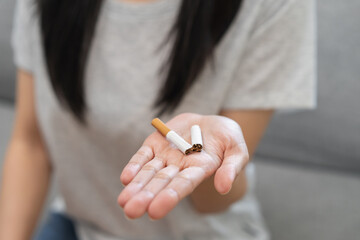 Quit smoke, No smoking health care concept, addiction asian young woman, girl refuse cigarette, smoker quitting smoke, hand in broken, holding break tobacco. Quit bad habit campaign, cancer disease.