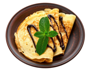 Crepes with chocolate sauce & mint on brown plate