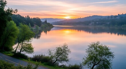 Fototapeta premium Serene Sunset Over Tranquil Lake Reflecting Golden Hues.