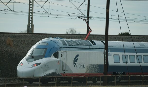 Wilmington, Delaware, U.S - Dec 26, 2025 - Acela electric train speeds along catenary-powered tracks with aerodynamic design