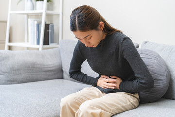 Flatulence ulcer, asian young woman, girl hands in belly, stomach pain from food poisoning, abdominal pain and digestive problem, gastritis or diarrhea. Abdomen inflammation, menstrual period people.