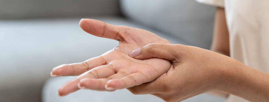 Close-up shot of human hands suffering from ligament inflammation on the palm.