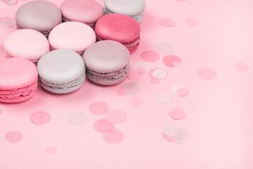 Obraz premium Group of pastel colorful macarons on trendy background. Vintage toning.