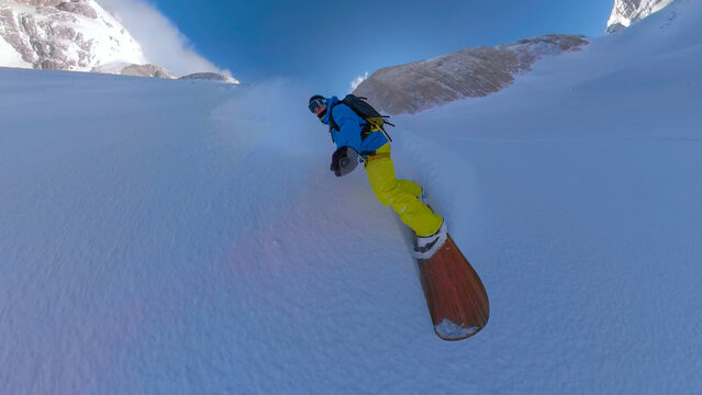 SELFIE: Young man on an amazing snowboard ride down a freshly snowed mountain