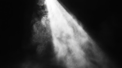 A bright beam of light illuminates a dark swirling vortex of dust particles creating a dramatic abstract atmosphere