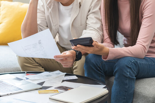 Stressed financial owe asian young couple love sitting suffer, stressed and confused by calculate expense from credit card bill, no money to pay, mortgage or loan. Debt, bankrupt or bankruptcy people.