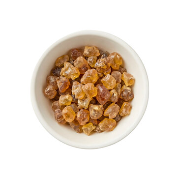 Dried tragacanth gum crystals in white bowl isolated on transparent background.