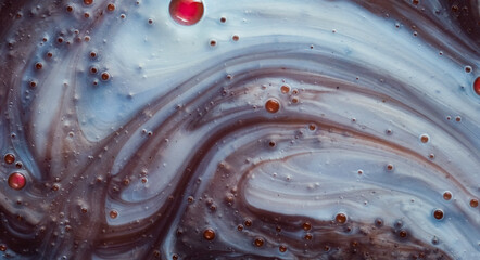 Abstract macro of liquid with bubbles and dynamic swirling flow in blue and brown tones. Ideal for science visuals, innovation concepts, cosmetic design, backgrounds, and modern branding