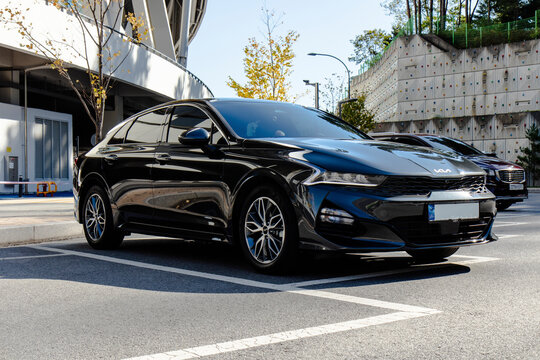 October 27, 2021, Seoul, South Korea - A black Kia K5 sedan parked in an outdoor parking lot on a sunny day.