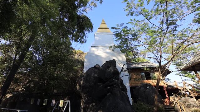 Aerial video view from a high mountain overlooking a beautiful tourist attraction in Lampang, Thailand Wat Chalerm Phra Kiat (Wat Phra Phutthabat Sutthawas),featuring an ancient pagoda and a nature.