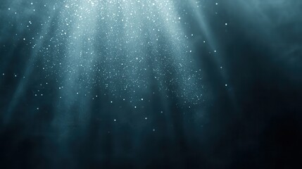 Abstract underwater background with shimmering particles and rays of light