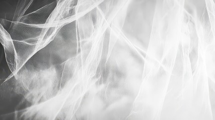 Delicate white tulle fabric shimmering faintly creating an abstract translucent textured background