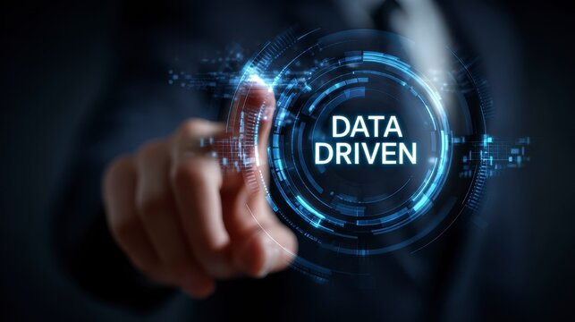 A person in a formal suit touches a glowing virtual interface with the text "DATA DRIVEN" surrounded by digital circuits - Powered by Adobe
