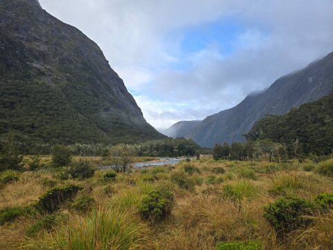 The Sun Rises through the Misty Mountains in Fiordland, New Zealand