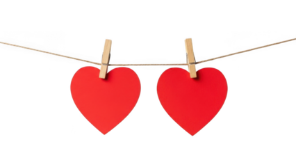 Two red hearts hanging on a string