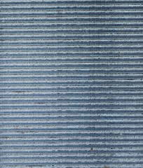 Macro close-up of textured aluminum metal surface with finned pattern and industrial detail