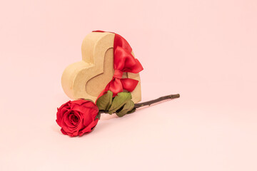 A romantic Valentine's Day gift card featuring a heart-shaped box with a bow and a rose. Festive background