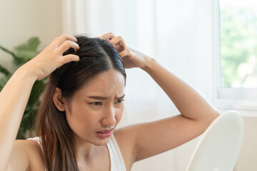 Young woman scratching her head feeling itch from dermatology problem