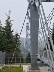 Sky Bridge 721 pedestrian suspension bridge in Doln&iacute; Morava, hanging 95 meters above the valley, disappearing into mist above green forest. Symbol of courage, space, and modern tourism.