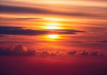 A beautiful canvas of colorful clouds and radiant light filling the atmosphere during the setting of the sun. The peaceful, dramatic natural background, orange, abstract, evening