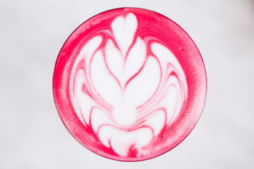 Trendy pink latte, macro. Beetroot or dragonfruit foam with latte art.