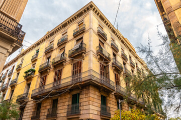 Facades of old buildings in the Gothic Quarter of Barcelona with balconies and typical Mediterranean architecture, Spain.