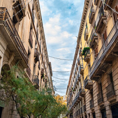 Facades of old buildings in the Gothic Quarter of Barcelona with balconies and typical Mediterranean architecture, Spain.