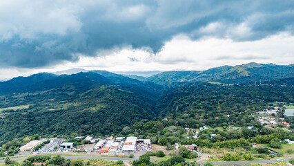 Panoramic Aerial Landscape of Tropical Mountains and Industrial Base under Stormy Clouds