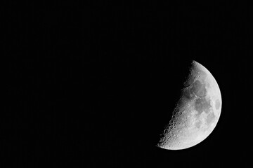Waxing Moon Phase with Detailed Lunar Craters Against Black Sky © AdobeTim82