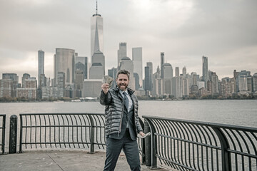 Businessman with dollar outdoor. Businessman excited with dollar money on street. Businessman in suit hold dollar cash. Mature man in suit hold 100 dollars banknotes at city. 100 dollars banknote.