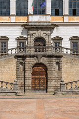 Italy - Caprarola - Palazzo Farnese - Main entrance portal with wooden door balcony and flags