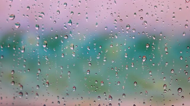 Close up view of raindrops on glass on background of blurred pastel colors. Miami Beach.