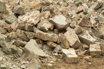 Pieces of limestone rocks are scattered across the mountain surface