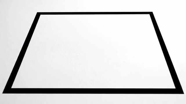 Asymmetrical rectangle outline on white surface with subtle texture and diffused shadows