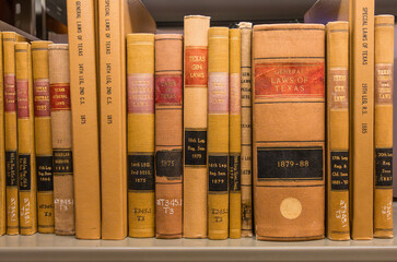 Old 19th Century law books on Texas statues passed in early legislative sessions of the government in the Texas State Capitol in Austin