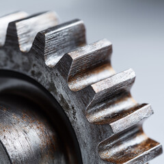 Macro view of polished steel gear teeth showing texture and precision for industrial power transmission and mechanical design.