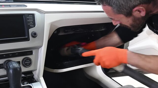 Professional vehicle detailing includes deep cleaning of the glove compartment with a brush and vacuum. Detailed interior cleaning and hygiene application.