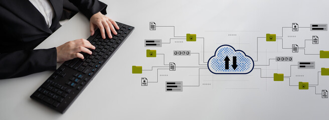 A business professional interacts with a keyboard while a cloud computing concept is depicted around them, illustrating the modern data management and workflow process in a digital workspace. Gantry
