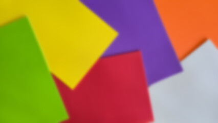 blurry horizontal banner background of assorted colored paper sheets. Flat lay of bright cardboard rectangles for design and craft projects, children's creativity, school activities, and DIY crafts