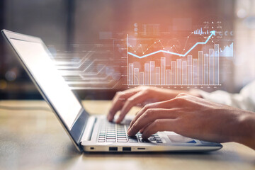 Focused professional engages with technology on a laptop, showcasing analysis and data visualization to signify advancements in finance and productivity strategies. Scalp
