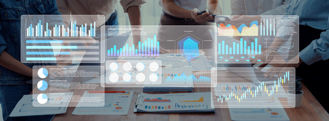 Team members collaborate in a modern workspace, analyzing data through digital interfaces, focusing on charts and graphs to drive business decisions. Gantry