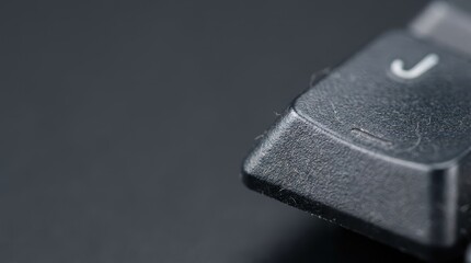 Detailed Macro View of a Dusty Black Keyboard Key with a Tactile Homing Bar on the Letter J